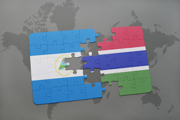 puzzle with the national flag of nicaragua and gambia on a world map