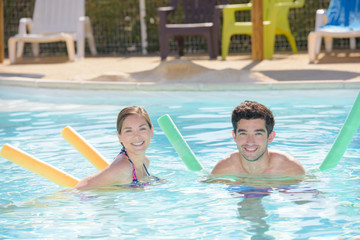Naklejka premium adults with pool noodles