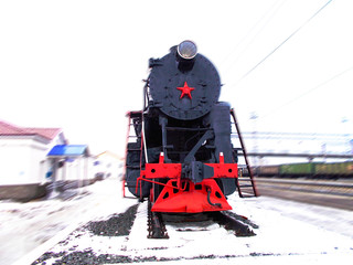 Old locomotive of the last century with a red star on the front side.