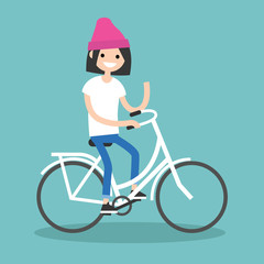 Fototapeta premium Young brunette girl riding a bike and waving her hand / editable flat vector illustration, clip art