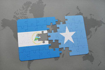 puzzle with the national flag of nicaragua and somalia on a world map