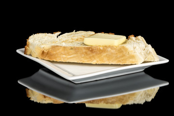 Slice of toasted bread with butter on it