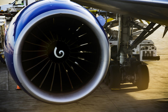 an airplane turbine detail with wing and undercarriage on the background