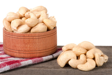 cashew nuts in a wooden bowl on the board isolated  white background