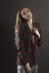 Beautiful young woman posing for model tests  in tartan jacket