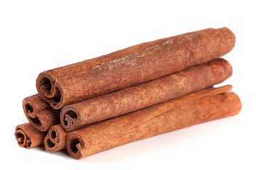 a stack of cinnamon sticks isolated on white background