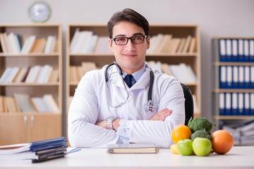 Doctor in dieting concept with fruits and vegetables
