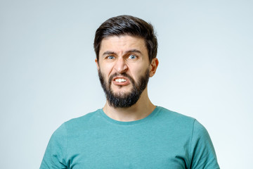 Portrait of young man with sad face expression