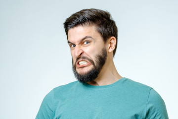 Fototapeta premium Angry and furious male on a gray background