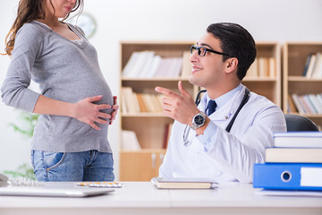 Fototapeta premium Pregnant woman visiting doctor for consultation