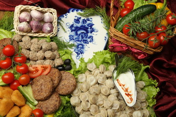 Dumplings. cutlet, tomatoes and cucumbers.