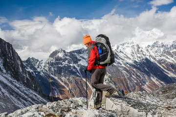 Trekker goes down fron Larke La pass on Manaslu circuit trek in Nepal