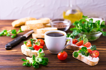 Bruschetta with ricotta, corn salad and cherry tomatoes. Coffee.