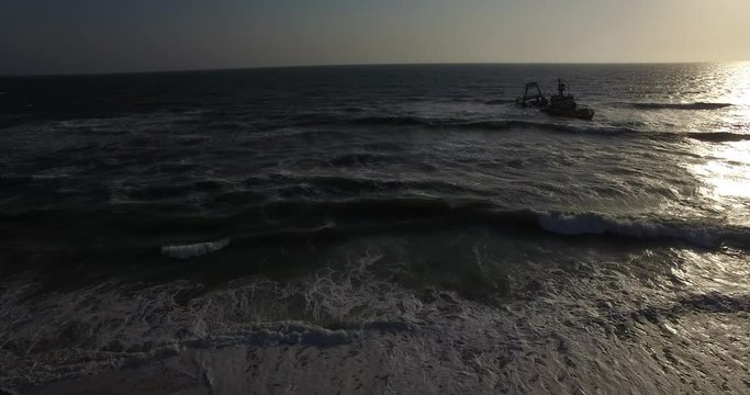 4K aerial drone video view of Namibian Atlantic coastline, Zeila L-758  Walvis Bay shipwreck and sand beach, Skeleton Coast Park landscape with ocean background at Namibia's west coast