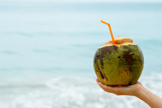 Female hand with a coconut