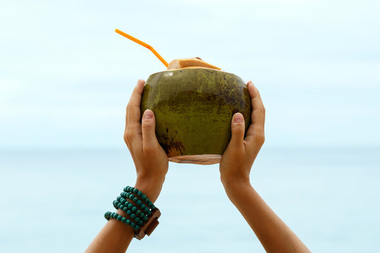 Female hands with a coconut