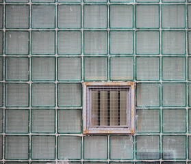 A window in a glass wall made of thick-walled batch cells