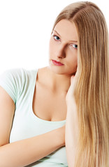 Naklejka premium A young sad woman, isolated on white background.