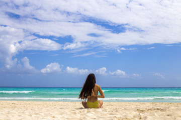 Fototapeta na wymiar Woman practicing meditation on the beach