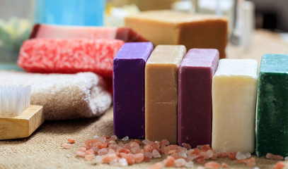 Variety of soap bars on wooden background