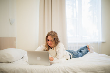 Portrait of a gorgoeus young blond woman shopping online using laptop