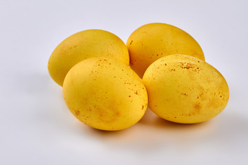 Yellow dyed eggs isolated. Four eggs on white background.