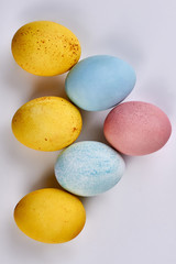Fototapeta na wymiar Dyed eggs on blank background. Yellow and blue eggs.