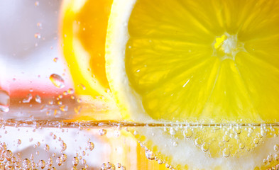 orange and lemon slice in sparkling water