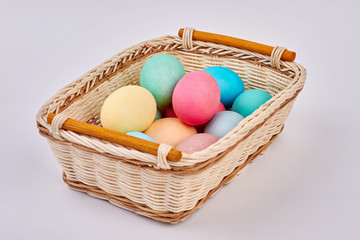 Painted eggs in basket. Pile of colorful Easter eggs. Symbol of religious holiday.