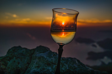 sunset in wineglass. crimson sky