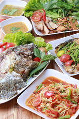 Mix Thai food on wooden floor in Thailand style.