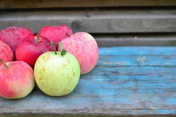 Natural ripe red apples on a blue background