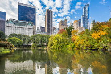 Fototapeta na wymiar Central Park Autumn and buildings reflection in midtown Manhattan New York City