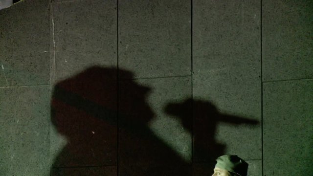 A dramatic shadow of the singing man on the wall