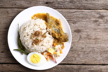 Nasi dagang, a popular Malaysian meal on the east coast of the Malaysian Peninsular. It consists of rice steamed in coconut milk, fish curry, hard boiled eggs and pickled vegetables.