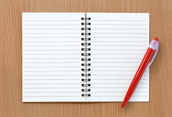 Empty notebook and red pen.