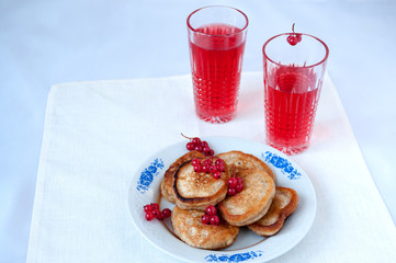 Fototapeta na wymiar Pancakes with berries red currant and juice