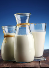 milk products - tasty healthy dairy products on a table on: and milk jar, glass bottle and in a glass