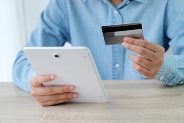 Woman hands using tablet and holding credit card, shopping online concept, business and technology