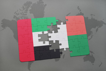 puzzle with the national flag of united arab emirates and madagascar on a world map