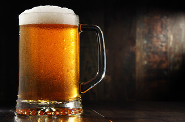 Composition with glass of beer on wooden background