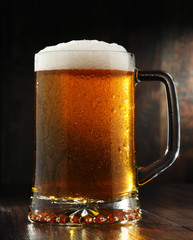 Composition with glass of beer on wooden background