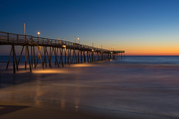 Fototapeta na wymiar Sunrise on Long Wooden Fishing Pier