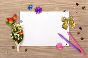 The sheet of paper, the bunch, bow and the two pencils from above.