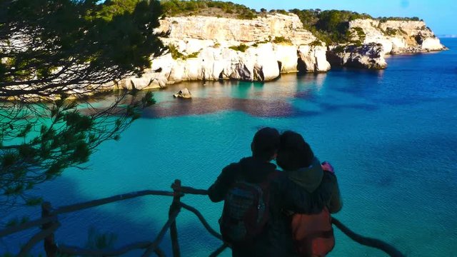 Menorca, a couple enjoying the view of Cala Macarella