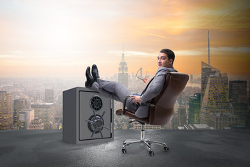 Businessman resting putting leg on safe