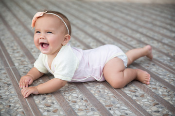 Baby girl crawling outside