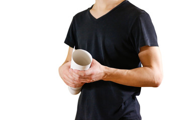 Guy holds in his hands twisted up in paper. Opens the package of paper. Shows a blank sheet rolled...