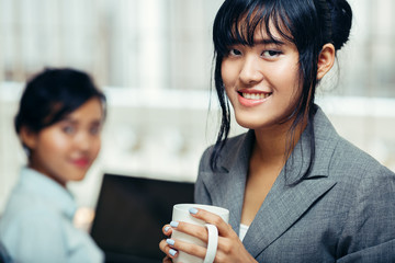 Colleagues relaxing and chitchat with hot coffee