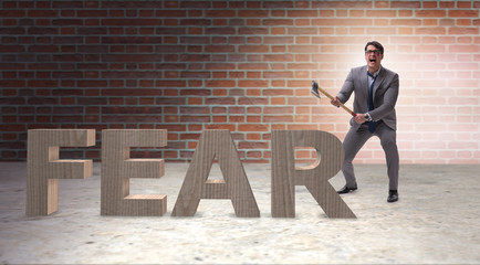 Angry man with axe axing the word fear